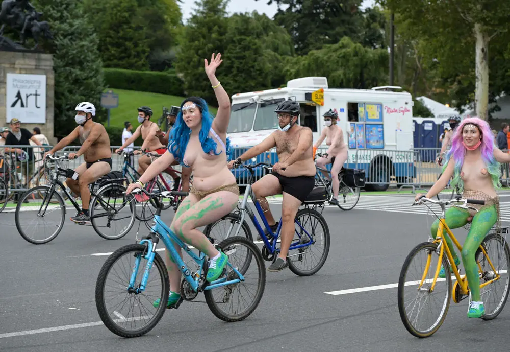 28 August 2021, US, Philadelphia: Naked people ride bicycles through the streets of Philadelphia to promote cycling advocacy, positive body image and economic sustainability. The Philly naked bike ride is an annual August event but had been cancelled last year due to COVID-19. Photo: Ricky Fitchett/ZUMA Press Wire/dpa