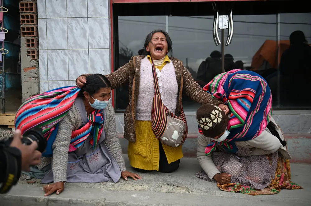 21 September 2021, Bolivia, La Paz: An elderly woman reacts during a rally called by Coca farmers in front of a hospital. A coca farmer leader had been injured by rival groups and admitted to hospital. Photo: Radoslaw Czajkowski/dpa