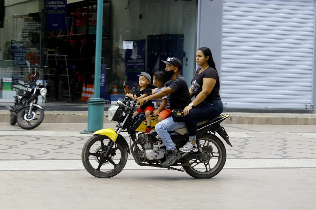 03 October 2021, Venezuela, Valencia: Four members of a family ride a motorcycle in Valencia. Photo: Juan Carlos Hernandez/ZUMA Press Wire/dpa