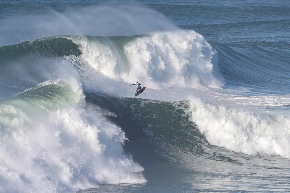 13 December 2021, Portugal, Nazare: Portuguese surfer Joao De Macedo rides a wave during the TUDOR Nazare Tow Surfing Challenge at Nazare's North Beach. Photo: Pedro Fiuza/ZUMA Press Wire/dpa.