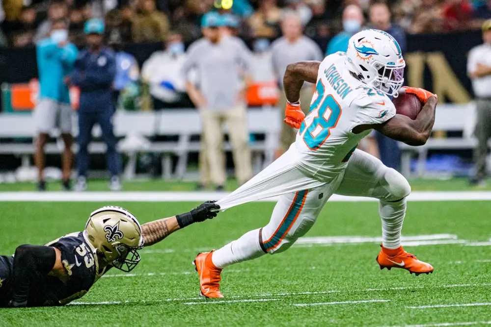27 December 2021, US, New Orleans: New Orleans Saints linebacker Zack Baun (L) tries to keep a hold of Miami Dolphins running back Duke Johnson during the US National Football League (NFL) match between New Orleans Saints and Miami Dolphins at Caesars Superdome stadium. Photo: Dan Anderson/ZUMA Press Wire/dpa.
