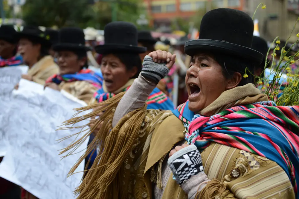 11 January 2022, Bolivia, La Paz: Women in traditional dress shout slogans during a protest against the introduction of a Corona vaccination certificate. Photo: Radoslaw Czajkowski/dpa.