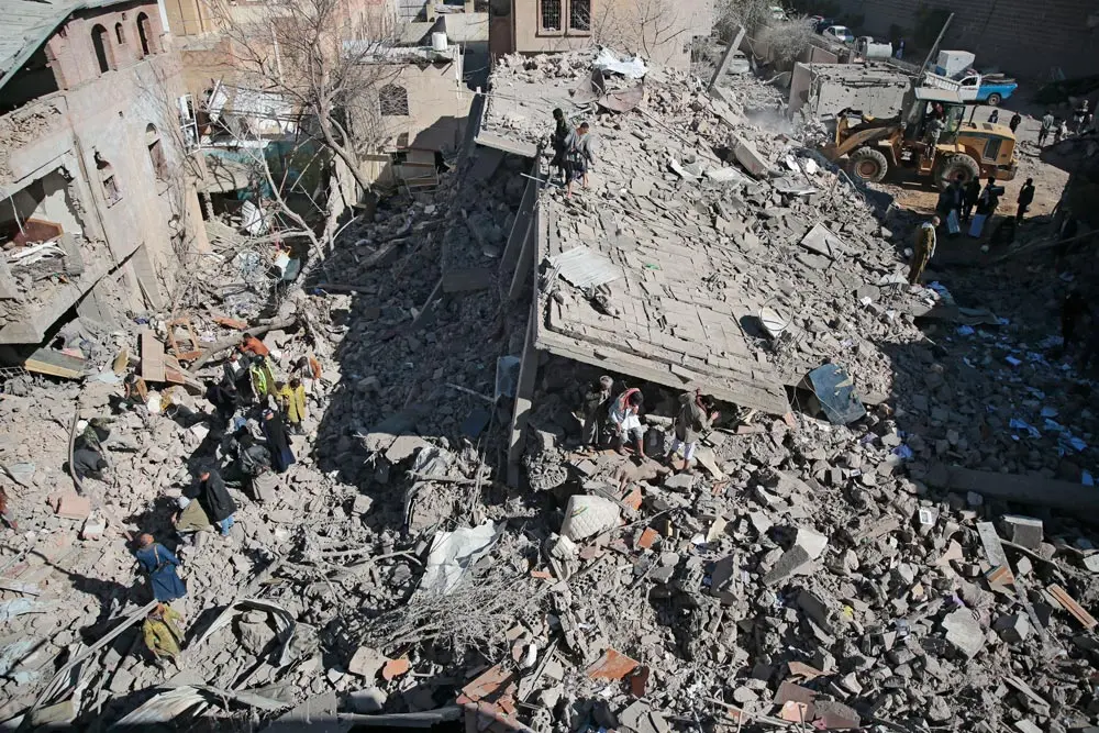 18 January 2022, Yemen, Sanaa: Yemeni people inspect a damaged building at the site of a Saudi-led air strike on Sanaa. At least 12 people were killed in strikes carried out by the Saudi-led military coalition on Yemen's rebel-held capital Sana'a, a rebel official said on Tuesday. Photo: Hani Al-Ansi/dpa.