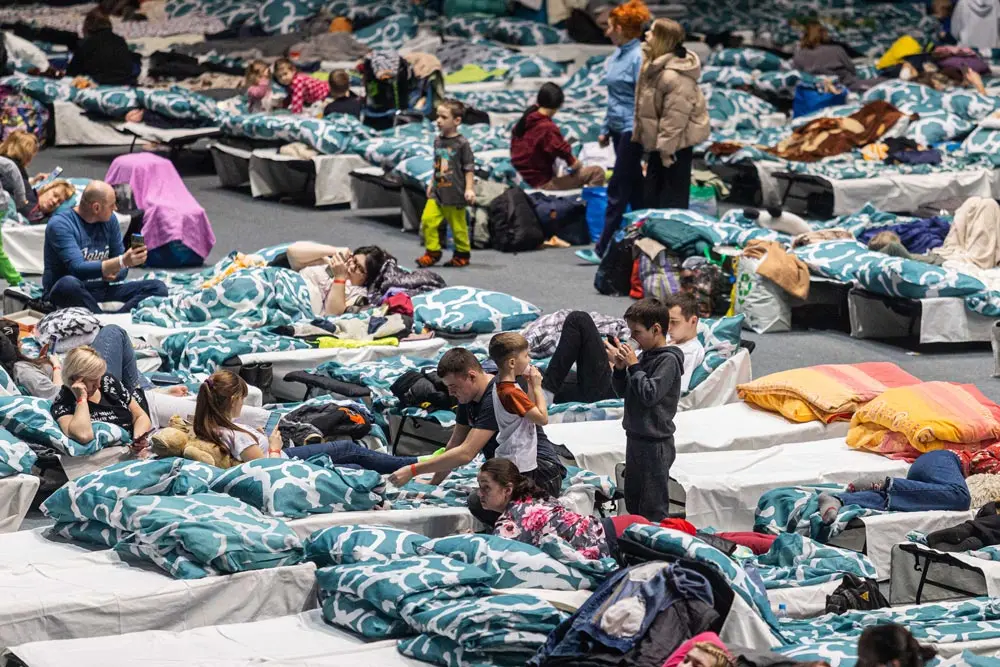 16 March 2022, Poland, Wroclaw: Refugees from Ukraine stay at a reception point which was set up in a sports hall in Wroclaw. According to the United Nations' International Organization for Migration, around 3 million people have fled the war in Ukraine. Photo: Krzysztof Kaniewski/ZUMA Press Wire/dpa.