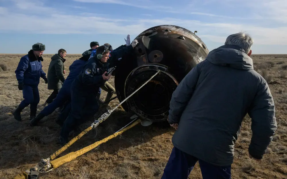 HANDOUT - 30 March 2022, Kazakhstan, Zhezkazgan: Russian Search and Rescue teams arrive at the Soyuz MS-19 spacecraft shortly after it landed in a remote area near the Kazakh town of Zhezkazgan. Astronaut Mark Vande Hei joined cosmonauts Anton Shkaplerov and Pyotr Dubrov on their return trip to Earth, quashing speculation that Vande Hei might not fly back on the Russian spacecraft in light of tensions over the war in Ukraine. Photo: Bill Ingalls/NASA/dpa - ATTENTION: editorial use only and only if the credit mentioned above is referenced in full.