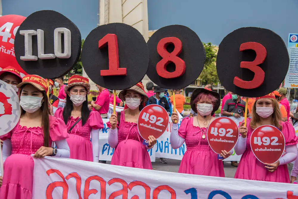 01 May 2022, Thailand, Bangkok: Protesters dressed as pregnant women hold signs of C183, the International Labor Organization's law which is concerning maternity protection, during a protest organized by Thai labour unions and migrant labour unions at the Democracy Monument to mark the International Labor Day and call for workers' rights and maternity rights for women workers. Photo: Peerapon Boonyakiat/SOPA Images via ZUMA Press Wire/dpa.