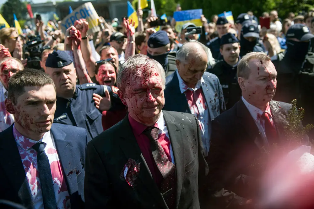 09 May 2022, Poland, Warsaw: Russia's ambassador to Poland, Sergey Andreev covered in red paint leaves the Soviet soldiers' cemetery following a ceremony on the day of the 77th anniversary of the 1945 Soviet victory against Nazi Germany. Andreev was hit with red paint by protesters opposed to the war in Ukraine at an annual Victory Day event. Photo: Attila Husejnow/SOPA Images via ZUMA Press Wire/dpa.