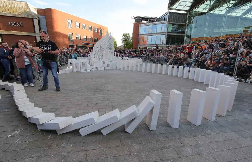 13 May 2022, United Kingdom, Norwich: A giant domino topple across Norwich marks the opening of the 250th anniversary edition of the Norfolk & Norwich Festival. Photo: Chris Radburn/PA Wire/dpa.