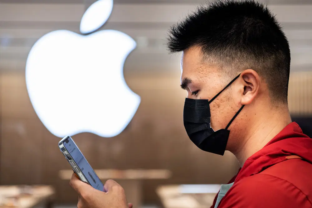 21 May 2022, China, Wuhan: A Chinese customer examines an iphone during the official opening of the new Apple flagship store at the Wuhan International Plaza. Photo: Ren Yong/SOPA Images via ZUMA Press Wire/dpa.