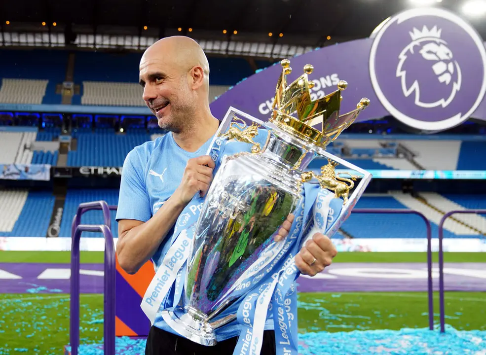 22 May 2022, United Kingdom, Manchester: Manchester City manager Pep Guardiola with the Premier League trophy following the English Premier League soccer match between Manchester City and Aston Villa at the Etihad Stadium. Photo: Martin Rickett/PA Wire/dpa.