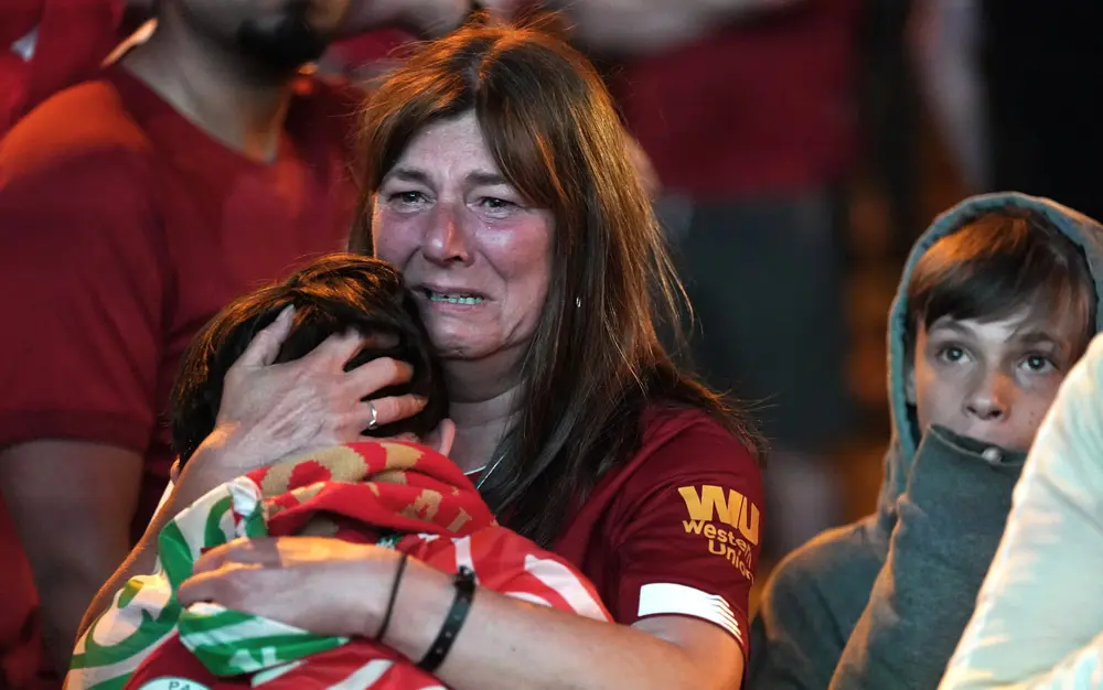 28 May 2022, France, Paris: Liverpool fans in the fanzone in Paris, react after seeing their team lose against Real Madrid in the UEFA Champions League Final at the Stade de France. Photo: Jacob King/PA Wire/dpa.