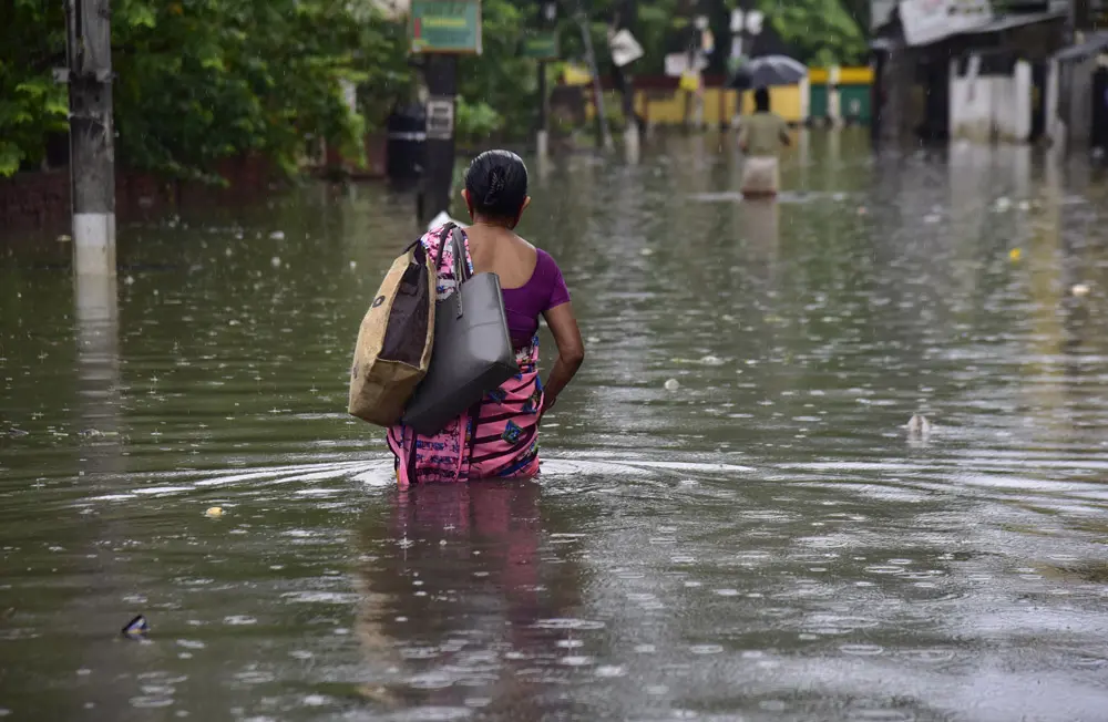 15 June 2022, India, Guwahati: A woman wades through a flooded street after heavy rain in Guwahati Assam. Photo: Dasarath Deka/ZUMA Press Wire/dpa.