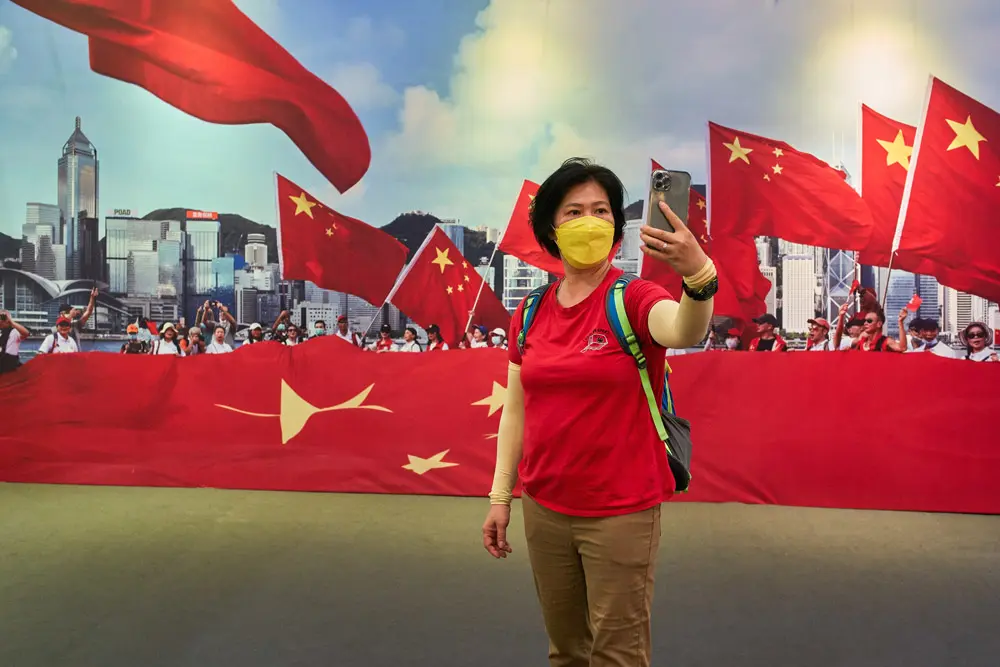 26 June 2022, China, Hong Kong: A woman takes a selfie at an exhibition celebrating the 25th anniversary of Hong Kong's return to the motherland in Wan Chai district. Photo: Emmanuel Serna/SOPA Images via ZUMA Press Wire/dpa.