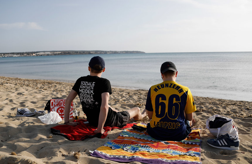 27 March 2021, Spain, Palma: German tourists from Leipzig Lucas and Marcel relax on the beach of Arenal. Photo: Clara Margais/dpa