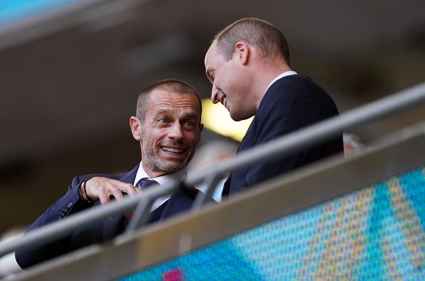 07 July 2021, United Kingdom, London: Prince William, Duke of Cambridge, talks with UEFA president Aleksander Ceferin (L) in the stands prior to the start of the UEFA Euro 2020 semi-final soccer match between England and Denmark at Wembley Stadium. Photo: Mike Egerton/PA Wire/dpa