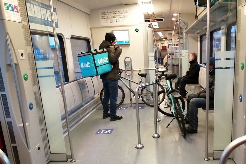 Wolt deliverymen, with their bicycles inside a train in Helsinki. Photo: The Nomad Today.