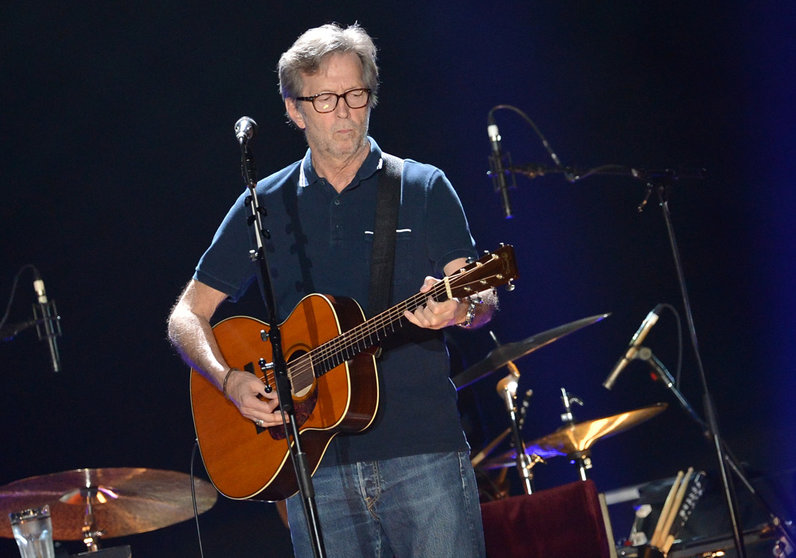 FILED - 30 May 2013, Berlin: British singer Eric Clapton performs on the stage of o2 World in Berlin. Clapton has waived his claims against a German woman after winning a case about bootleg CDs, according to a statement on his homepage. Photo: Britta Pedersen/dpa-Zentralbild/dpa.