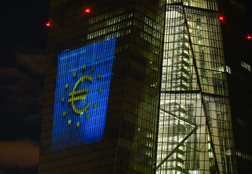 30 December 2021, Hessen, Frankfurt/Main: The European Currency "Euro" symbol is projected onto the south facade of the European Central Bank's (ECB) headquarters in Frankfurt's East End. On New Year's Eve 20 years ago, the single European currency, the euro, was introduced in twelve EU countries. Photo: Arne Dedert/dpa.