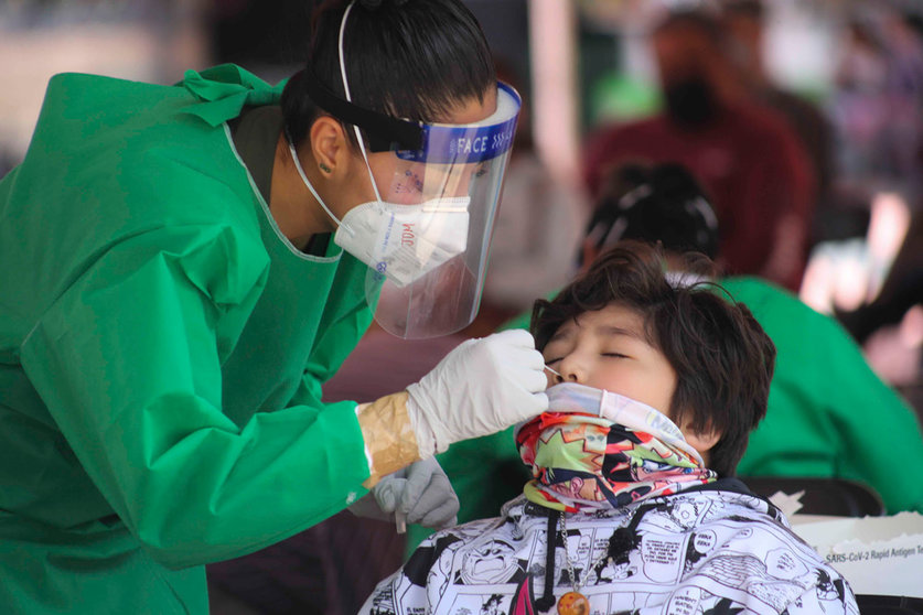 FILED - A health worker takes a swab for a coronavirus test from a child at a test centre in Toluca. Photo: -/El Universal via ZUMA Press Wire/dpa.
