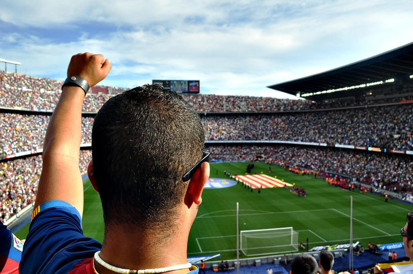 A Barcelona fan cheers from the Camp Nou stands. Photo: Pixabay.
