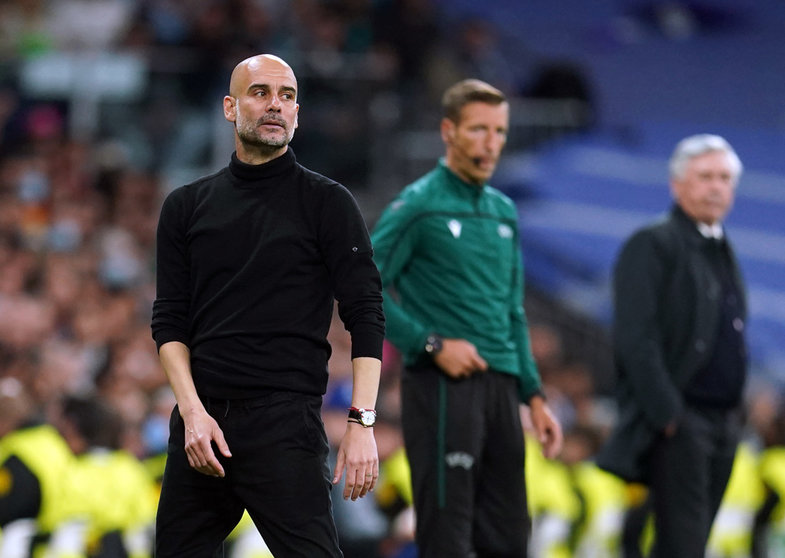 04 May 2022, Spain, Madrid: Manchester City manager Pep Guardiola (L) reacts from the touchlines during the UEFA Champions League semi final, second leg soccer match between Real Madrid and Manchester City at the Santiago Bernabeu. Photo: Nick Potts/PA Wire/dpa.