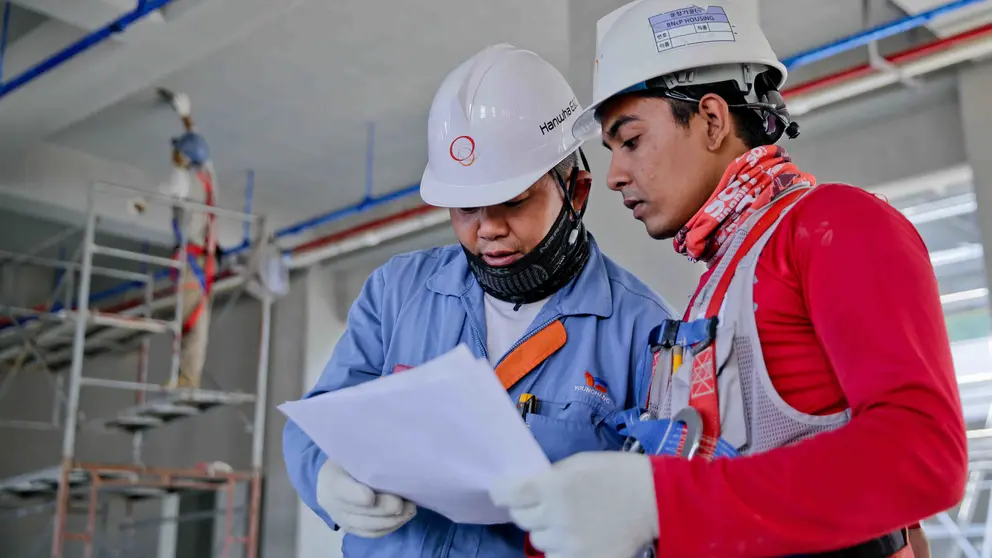 Men workers construction helmets