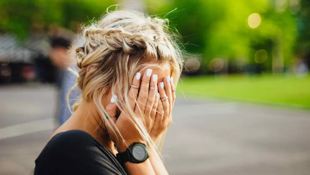 Woman blonde hands face by Abigail Keenan