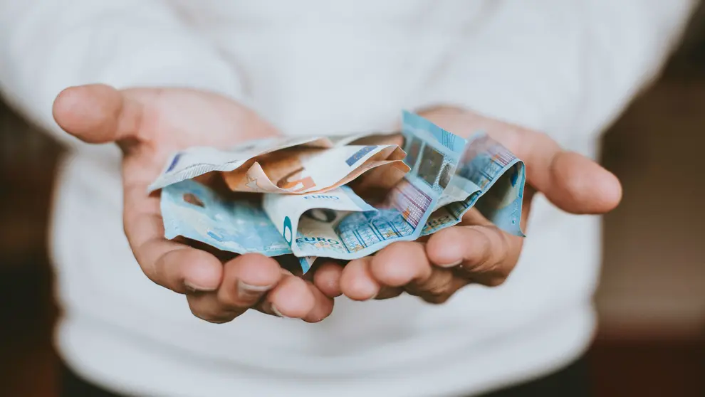 Money euros hands by Christian Dubovan on Unsplash