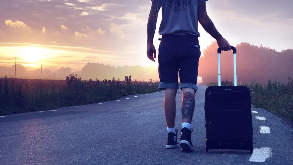 Hiker-suitcase-man-road-walk