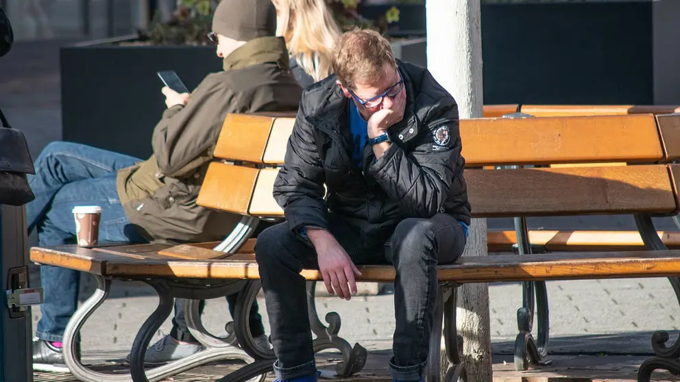 Man-sitting-bench-unemployment-unemployed-anguish