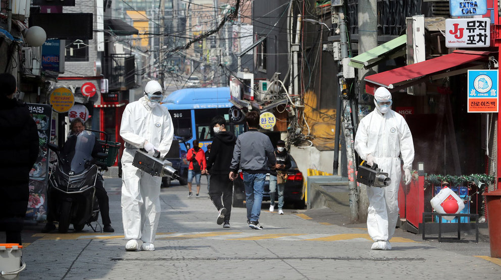 Quarantine workers spray disinfectants at night spots of Itaewon neighborhood, following the coronavirus disease (COVID-19) outbreak, in Seoul, South Korea, May 11, 2020. Yonhap/via REUTERS