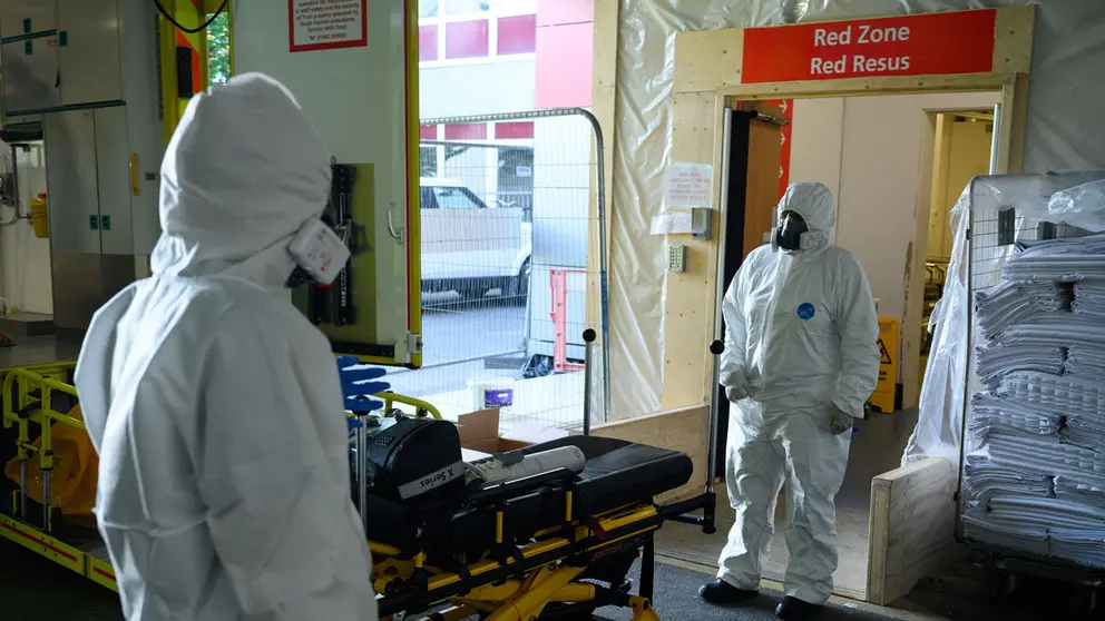 Emergency Car Assistant Sarah Morris and Paramedic Kate Donne wait to safely remove their PPE3-level clothing in the ambulance bay of Southampton General hospital, near Southampton, Britain May 6, 2020. Picture taken May 6, 2020. Leon Neal/Pool via REUTERS