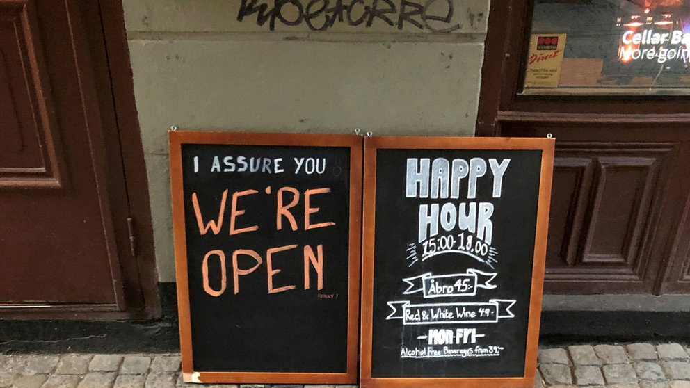 A sign assures people that the bar is open during the coronavirus outbreak, outside a pub in Stockholm, Sweden March 26, 2020. Picture taken March 26, 2020. REUTERS/Colm Fulton