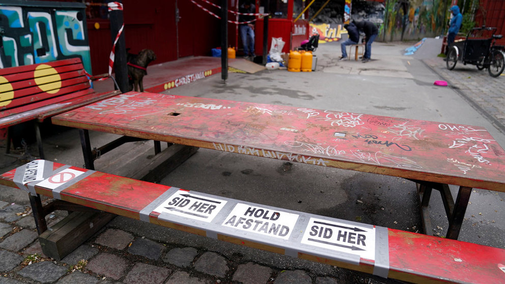 Social distancing markers are seen on a bench as the free community of Christiania reopens after nine weeks of closure to the public due to the lockdown to prevent the spread of the coronavirus disease (COVID-19), in Copenhagen, Denmark, May 16, 2020. Ritzau Scanpix/Tariq Mikkel Khan via REUTERS