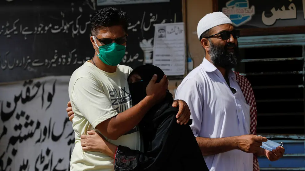 Family members mourn the death of a relative who was killed in a plane crash, outside a morgue in Karachi, Pakistan May 23, 2020. REUTERS/Akhtar Soomro