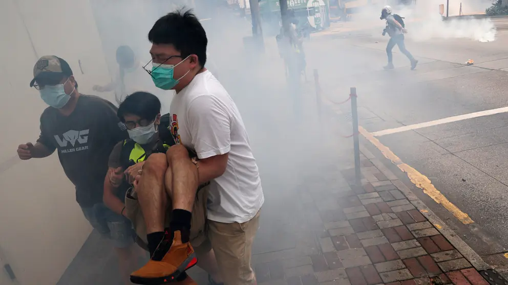 Anti-government protesters run away from tear gas during a march against Beijing’s plans to impose national security legislation in Hong Kong, China May 24, 2020. REUTERS/Tyrone Siu