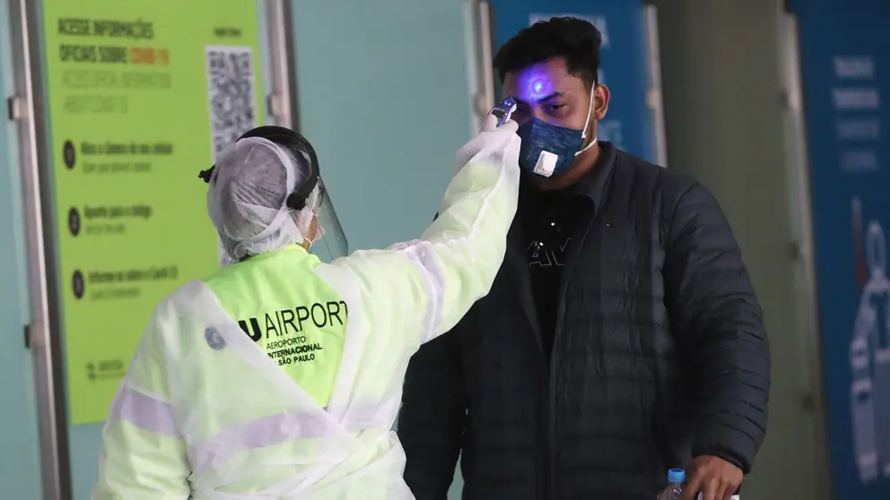 A man has his temperature checked before boarding a flight to United States at Guarulhos International Airport amid the outbreak of the coronavirus disease (COVID-19), in Guarulhos, near Sao Paulo, Brazil, May 25, 2020. REUTERS/Amanda Perobelli