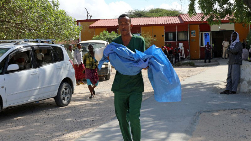 A paramedic at the Madina hospital carries an injured child after a minibus struck a roadside bomb at Hawa Abdi village, northwest of Mogadishu, Somalia May 31, 2020. REUTERS/Feisal Omar