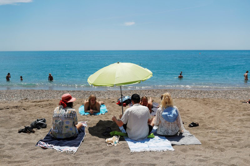 FILE PHOTO: People enjoy on La Malagueta beach as some Spanish provinces are allowed to ease lockdown restrictions during phase two, amid the coronavirus disease (COVID-19) outbreak, in Malaga, southern Spain June 1, 2020. REUTERS/Jon Nazca