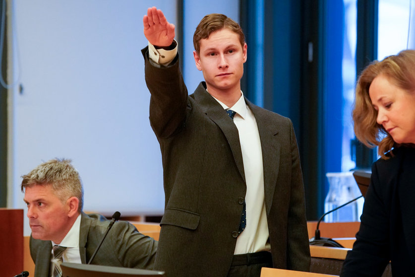 error suspect Philip Manshaus (C) flashes the Nazi salute during his trial on charges of carrying out the Baerum mosque mass shooting on August 10, 2019. On June 11, 2020, he was found guilty of the shooting and sentenced to 21 years of &#34;preventive detention,&#34; with the court saying he should serve at least 14 years. Photo: Heiko Junge/NTB scanpix/dpa
