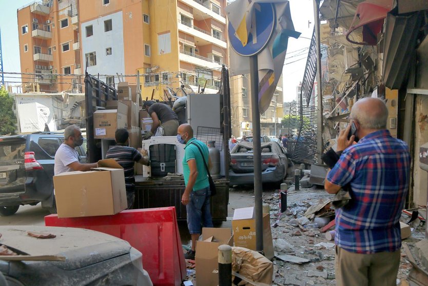 06 August 2020, Lebanon, Beirut: People put their belonging in a truck as they leave a destroyed area caused by a massive explosion in Beirut&#39;s port that rocked the whole city, killing at least 100 people and injured thousands. Photo: Marwan Naamani/dpa.
