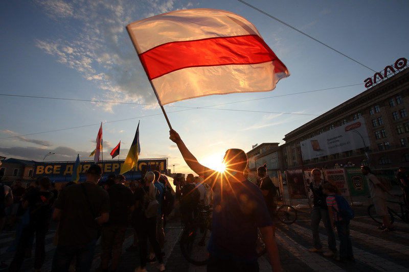 An activist waves flag of the Rada of the Belarusian Democratic Republic during a rally in solidarity with the Belarusian opposition. More than a thousand people were detained overnight in Belarus in a third night of protests following the presidential election. Photo: Ukrinform/dpa.