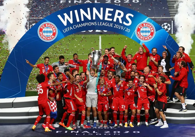 HANDOUT - 23 August 2020, Portugal, Lisbon: Bayern Munich&#39;s goalkeeper and captain Manuel Neuer (C) lifts the UEFA Champions League trophy following his team&#39;s victory in the UEFA Champions League Final soccer match between Paris Saint-Germain and Bayern Munich at the Estadio da Luz. Photo: Julian Finney/Getty Images via UEFA/dpa.