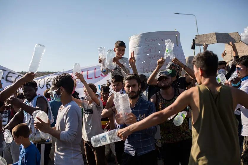 11 September 2020, Greece, Moria: Migrants take part in a protest to call for their resettlement after the massive fire that burnt out the refugee camp of Moria which almost destroyed it, leaving more than 12,000 migrants homeless. Photo: Socrates Baltagiannis/dpa.