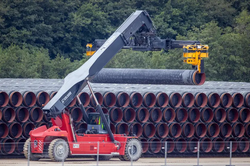 08 September 2020, Mecklenburg-Western Pomerania, Mukran: A special vehicle transports a pipe for the Nord Stream 2 natural gas pipeline to a storage yard at the port of Mukran on the island of Ruegen. Special ships are being prepared in the port for the further construction of the Nord Stream 2 Baltic Sea pipeline. Photo: Jens Büttner/dpa.