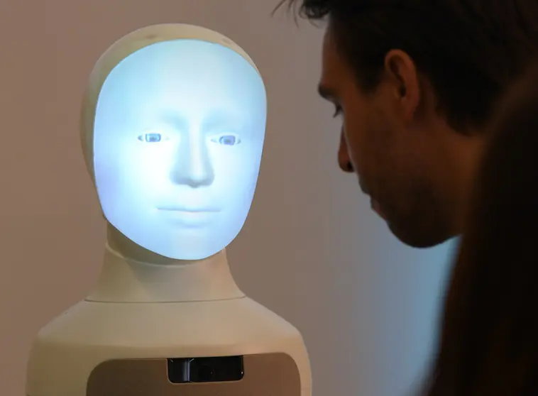 FILED - Patrick Schanowski, research assistant, communicates during a press conference at the TU Darmstadt with robot &#34;Alfie&#34;, a Moral Choice Machine, during the Center for Artificial Intelligence (AI) Presentation. Photo: Arne Dedert/dpa.