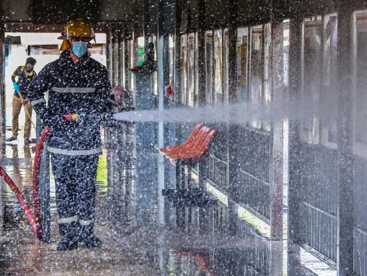 26 October 2020, Sri Lanka, Colombo: A Sri Lankan worker sprays disinfectant at Bastian Mawatha Bus terminal to prevent the spread of coronavirus in Colombo. Photo: Pradeep Dambarage/dpa.