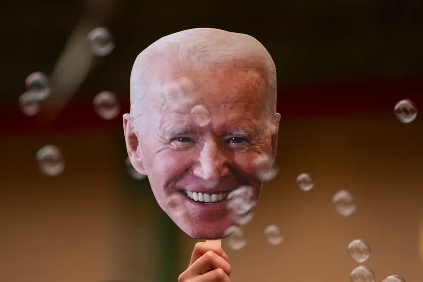 07 November 2020, US, Seattle: A person holds a picture of the US president-elect, Joe Biden, during celebrations in the street in Seattle after has won the election to become the US 46th president. Photo: David Ryder/dpa.