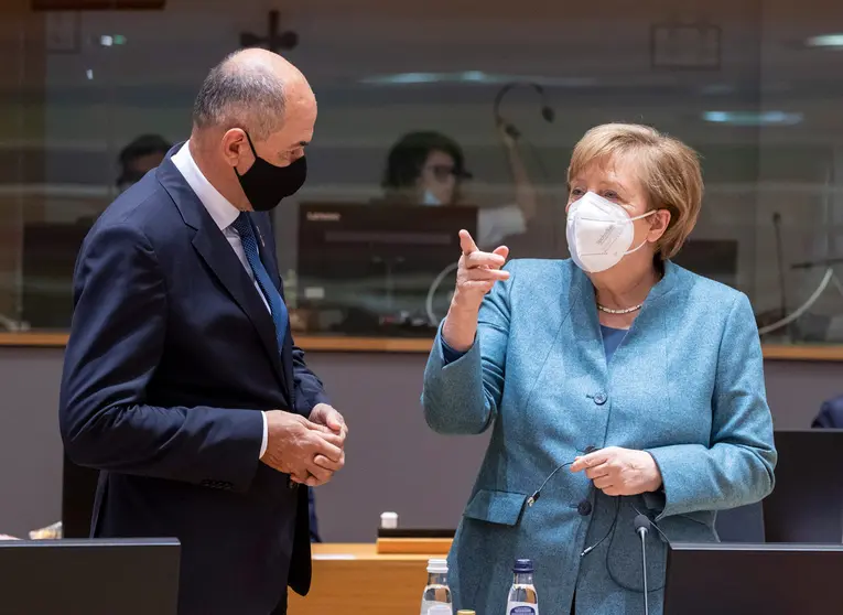 HANDOUT - 10 December 2020, Belgium, Brussels: German Chancellor Angela Merkel (R) talks with Slovenian Prime Minister Janez Jansa before the start of the first day of a two days face-to-face European Council summit. Photo: Zucchi Enzo/EU Council/dpa - ATTENTION: editorial use only and only if the credit mentioned above is referenced in full