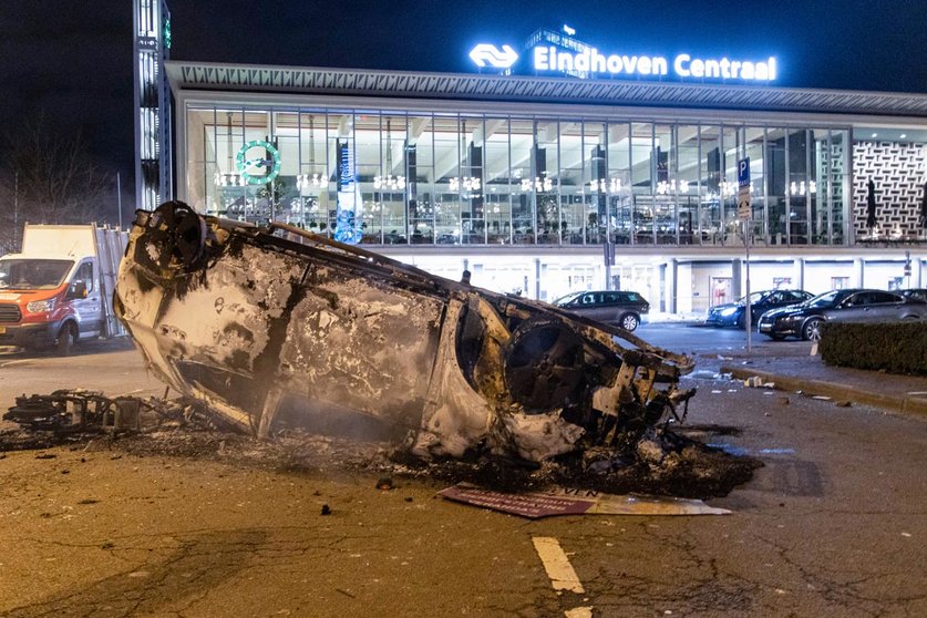 24 January 2021, Netherlands, Eindhoven: Debris of a burned out car can be seen in front of Eindhoven Central train station in the aftermath of a demonstration against the current coronavirus policy. Photo: Nik Oiko/SOPA Images via ZUMA Wire/dpa